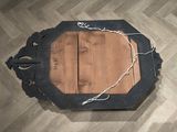 a picture of a wooden table with a rope around it