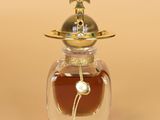 a small glass jar with a gold lid and a gold lid