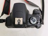 a camera that is sitting on a table with a strap around it