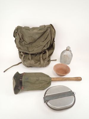 a bag, a bottle, a spoon, and other items on a white surface