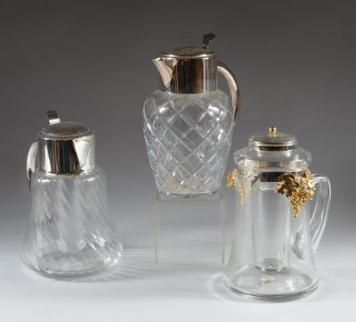 four pieces of glass and silverware including a pitcher, sugar and pepper shaker, and a salt shaker