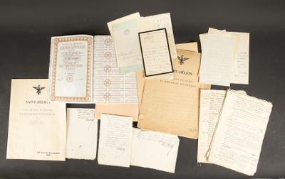 an assortment of old letters and papers on a black surface