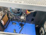 the inside of a computer case with a blue floor and a fan