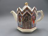 an image of a teapot with a picture of a man and a woman on it