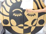 a woman holding a piece of paper in front of a sun