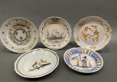four plates with different designs on them sitting on a table
