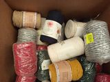 a box full of different colored yarns in it