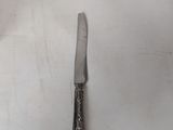 a knife that is laying on a white surface
