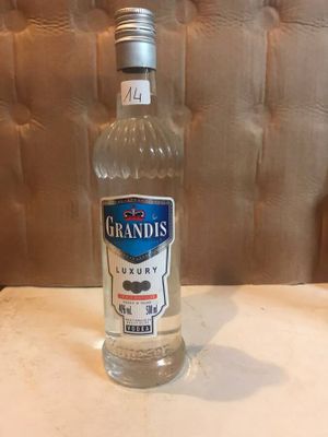 a bottle of liquor sitting on a table in a restaurant