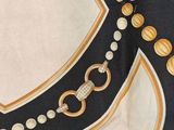 a close up of a scarf with beads on it