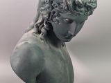 a statue of a young man with curly hair