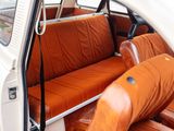 an orange seat in the back of a small car