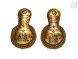 pair of brass bells with stars and numbers on them on a white background