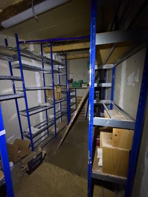 a room with shelves and boxes in it