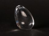 a clear glass object sitting on a black surface