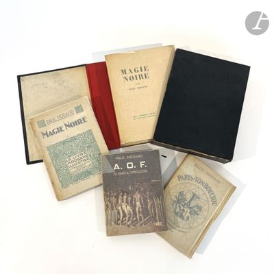 several books sitting on top of each other on a white surface