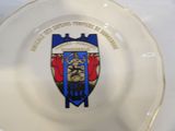 a white plate with a blue and red crest on it