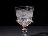 glass goblet on a black table with a black background
