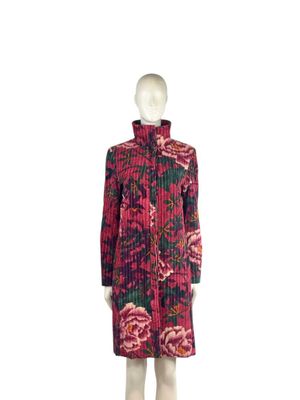 the mannequin is wearing a red and black dress with pink flowers