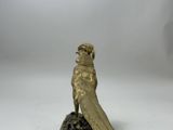 an image of a bronze statue of a bird on a marble base