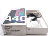 a box with a phone inside of it on a white surface
