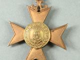 an image of a gold medal with a blue ribbon around it