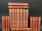 several old books stacked on top of each other on a black surface