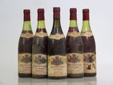 four bottles of wine are lined up on a table
