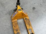 a person standing next to a forklift on the floor