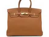 a brown leather handbag on a white background