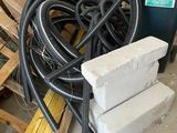a pile of pipes and a pile of bricks in a room