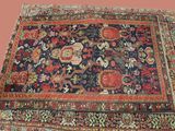 un tapis persan ancien sur fond rose avec un fond rose