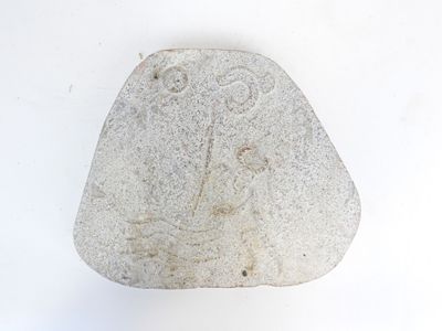 a rock with a drawing on it on a white surface