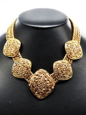 a close up of a necklace on a mannequin mannequin