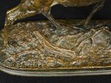 a bronze statue of a horse and a bird on a rock