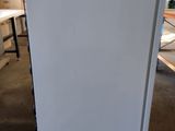 an image of a white refrigerator in a room