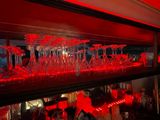 bottles and glasses are lined up on a shelf in a bar