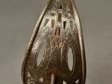 a silver spoon with a handle that has a design on it