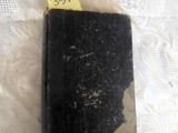 a black book with a yellow sticker on top of it