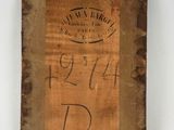 a close up of a piece of wood with writing on it