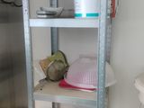 a metal shelving with various items on top of it