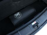 the trunk of a car with a black bag in the trunk