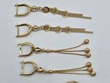 a close up of a bunch of gold jewelry on a table