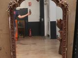 a man taking a picture of a mirror in a room