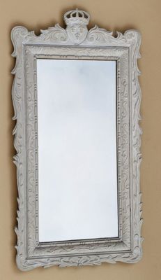 an image of a mirror hanging on a wall in a room