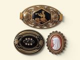 three different types of brooches on a white surface