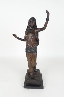 bronze statue of a woman holding her hands up in the air