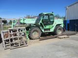 a picture of a green forklift parked in front of a building