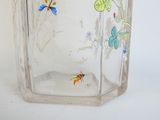 a glass vase with a butterfly design on it