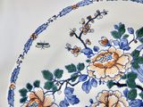 a blue and white plate with flowers on it
